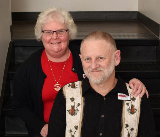 Dana & Alan Burk smiling at a social event, showcasing their friendly relationship.