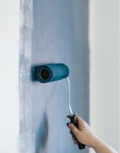 Painting wall with roller brush during home improvement.
